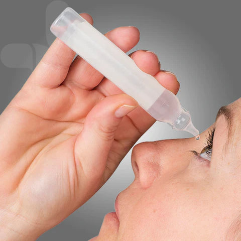 Person administering eye drops.